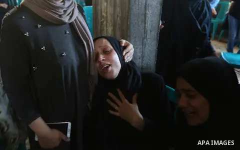 Relatives of Palestinian volunteer medic Abdullah Al-Kotati, who was killed the day before by Israeli troops while trying to help wounded protesters during clashes where Palestinians demand the right to return to their h...