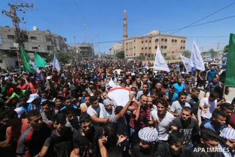 Mourners carry the bodies of Palestinian Ali Aloul, 55, and Ahmed Abu Louly who were killed by Israeli troops during clashes where Palestinians demand the right to return to their homeland at the Israel-Gaza border, duri...