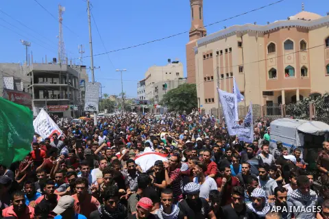 Mourners carry the bodies of Palestinian Ali Aloul, 55, and Ahmed Abu Louly who were killed by Israeli troops during clashes where Palestinians demand the right to return to their homeland at the Israel-Gaza border, duri...