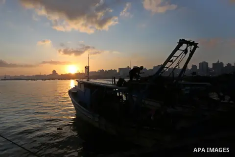 Palestinian fishermen ride their boat, at Gaza seaport, on August 15, 2018. The fishing zone off Gaza's coast was also restored to 17km (nine nautical miles), having been reduced to 6km. Photo by Ashraf Amra