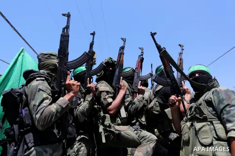 Members of the Islamist movement Hamas' military wing Al-Qassam Brigades attend the funeral of their comrade Karim Abu Fatayer, 30, who was killed by Israeli troops the day before during clashes at Israel-Gaza border, in...