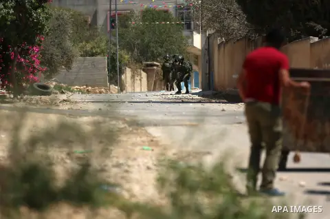 Israeli forces take position during clashes with Palestinian protesters following a weekly demonstration against the expropriation of Palestinian land by Israel in the village of Kfar Qaddum, near the West Bank city of N...