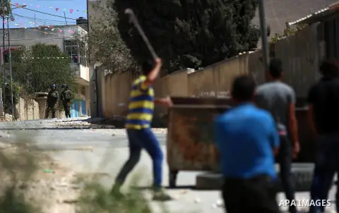 Israeli forces take position during clashes with Palestinian protesters following a weekly demonstration against the expropriation of Palestinian land by Israel in the village of Kfar Qaddum, near the West Bank city of N...
