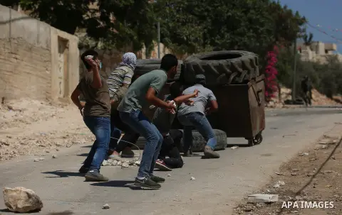 Israeli forces take position during clashes with Palestinian protesters following a weekly demonstration against the expropriation of Palestinian land by Israel in the village of Kfar Qaddum, near the West Bank city of N...