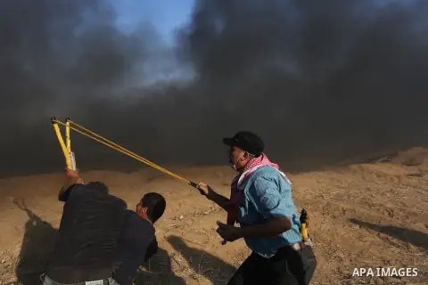 Palestinian protesters gather during clashes with Israeli troops in tents protest where Palestinians demand the right to return to their homeland at the Israel-Gaza border, in Khan Younis in the southern of Gaza Strip on...