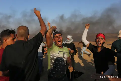 Palestinian protesters gather during clashes with Israeli troops in tents protest where Palestinians demand the right to return to their homeland at the Israel-Gaza border, in Khan Younis in the southern of Gaza Strip on...