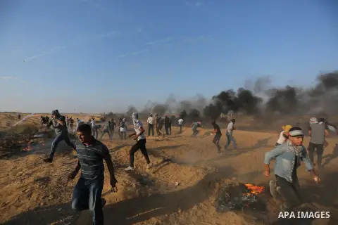 Palestinian protesters gather during clashes with Israeli troops in tents protest where Palestinians demand the right to return to their homeland at the Israel-Gaza border, in Khan Younis in the southern of Gaza Strip on...