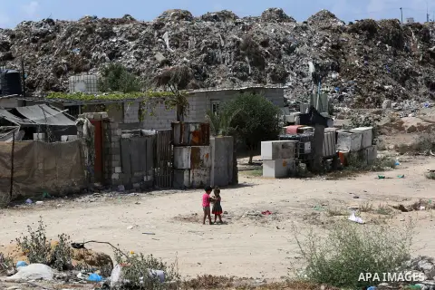 Palestinian children play outside a tin house in an impoverished neighbourhood of the Khan Younis refugee camp in southern Gaza Strip on August 27, 2018. The United States said that it had cancelled more than two hundred...