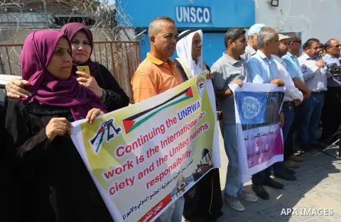 Palestinians hold banners during a protest against a U.S. decision to cut aid in front of the headquarter United Nation "UNSCO", in Gaza city on September 4, 2018. The United States halted all funding to United Nations'...
