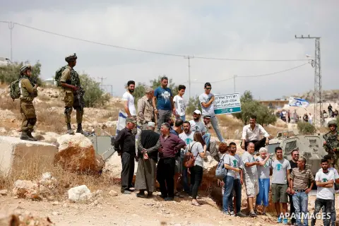 Palestinian protesters take part during a demonstration against the closure of a road since 18 years by the Israeli army in the West Bank village of Khirbat Qalqas, south of Hebron, on September 7, 2018. Photo by Wisam H...