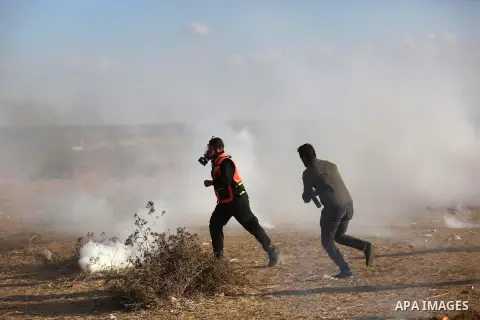 Palestinian protesters gather during clashes with Israeli troops in tents protest where Palestinians demand the right to return to their homeland at the Israel-Gaza border, in Khan Younis in the southern Gaza Strip on Se...