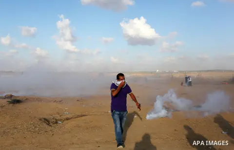 Palestinian protesters gather during clashes with Israeli troops in tents protest where Palestinians demand the right to return to their homeland at the Israel-Gaza border, in Khan Younis in the southern Gaza Strip on Se...