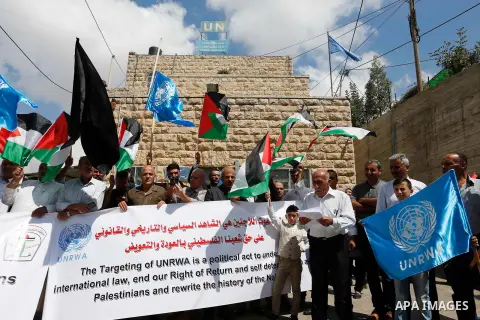 Palestinians take part during a protest against the United States decision to stop funding and backing the United Nations Relief and Works Agency (UNRWA) in the West Bank city of Hebron on September 8, 2018. The United S...