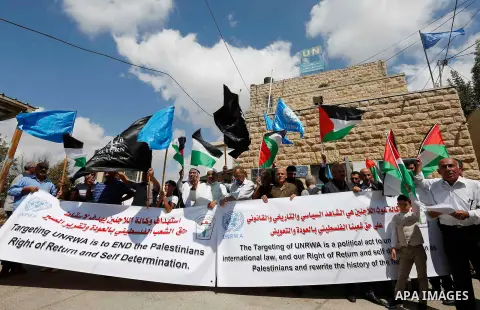 Palestinians take part during a protest against the United States decision to stop funding and backing the United Nations Relief and Works Agency (UNRWA) in the West Bank city of Hebron on September 8, 2018. The United S...