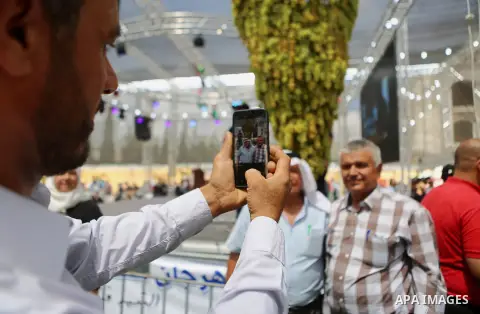 Palestinians attend the Palestinian grapes festival in Halhoul village, near the West Bank city of Hebron, on September 10, 2018. Hebron is very famous in grape production as it contains many fields of grapes, the summer...