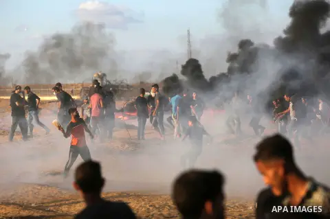Palestinian protesters gather during clashes with Israeli troops in tents protest where Palestinians demand the right to return to their homeland at the Israel-Gaza border, in Khan Younis in the southern Gaza Strip on Se...