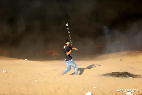 Palestinian protesters gather during clashes with Israeli troops in tents protest where Palestinians demand the right to return to their homeland at the Israel-Gaza border, in Khan Younis in the southern Gaza Strip on Se...
