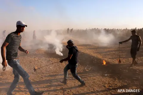 Palestinian protesters gather during clashes with Israeli troops in tents protest where Palestinians demand the right to return to their homeland at the Israel-Gaza border, in Khan Younis in the southern Gaza Strip on Se...