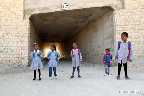 Palestinian Bedouin school children walk in the village of Khan al-Ahmar in the Israeli occupied West Bank on September 16, 2018. Photo by Wisam Hashlamoun