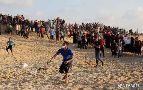 Palestinian protesters gather during clashes with Israeli forces in a demonstration against the Israeli blockade on Gaza Strip, along the Gaza sea barrier on the maritime border with Israel near Kibbutz Zikim, north of B...