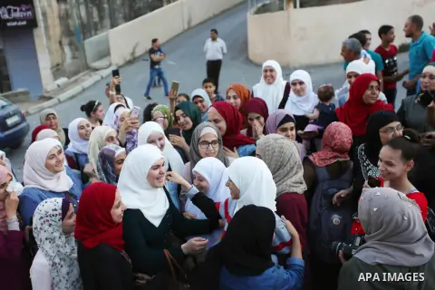 Palestinian student Ola Marshoud is greeted by relatives and friends at the Israeli checkpoint of Al-Jalameh, south of the West Bank city of Jenin following her release from an Israeli jail on September 20, 2018 after se...