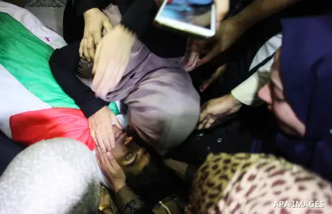 Relatives of Palestinian Kareem Kullab, 25, who was shot dead by Israeli forces during clashes in tents protest where Palestinians demand the right to return to their homeland at the Israel-Gaza border, mourn over his bo...
