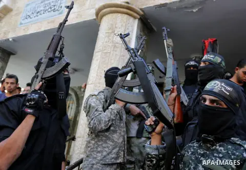 Palestinian militants of the Nasser Salah al-Din Brigades the military wing of the Popular Resistance movement attend the funeral of Palestinian Mohamed Abu Sadek, 21, who was shot dead by Israeli forces during clashes a...