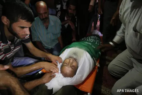 Relatives of an elderly Palestinian Ibrahim al-Arrouqi, 78, who was shot dead by Israeli forces mourn over his body during his funeral in al-Maghazi in the center of the Gaza Strip on October 3, 2018. Photo by Ashraf Amr...