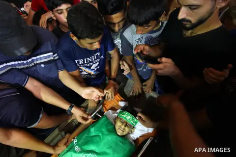 Relatives of Palestinian boy Faris al-Sersawi, 12, who was shot dead by Israeli froces during clashes in tents protest where Palestinians demand the right to return to their homeland at the Israel-Gaza border, mourn over...