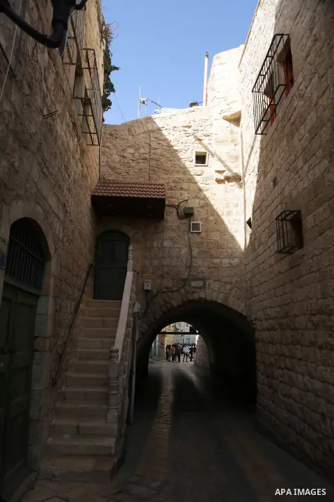 Palestinians walk at a street in the Old City of the West Bank city of Bethlehem on October 22, 2018. Photo by Shadi Hatem