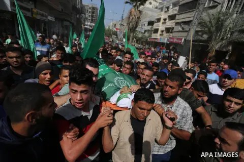 Mourners carry the body of Palestinian Muntaser al-Baz, who was shot dead by Israeli forces during a protest at the Israel-Gaza border, during his funeral in Dair Al Balah in the central Gaza Strip, on October 24, 2018....