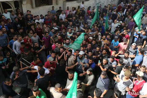 Mourners carry the body of Palestinian Muntaser al-Baz, who was shot dead by Israeli forces during a protest at the Israel-Gaza border, during his funeral in Dair Al Balah in the central Gaza Strip, on October 24, 2018....