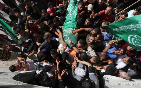 Mourners carry the body of Palestinian Muntaser al-Baz, who was shot dead by Israeli forces during a protest at the Israel-Gaza border, during his funeral in Dair Al Balah in the central Gaza Strip, on October 24, 2018....