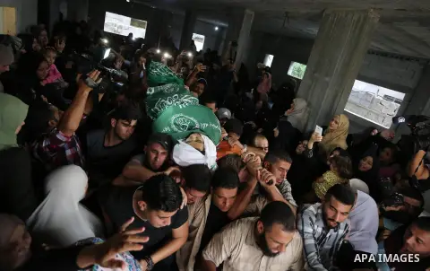 Mourners carry the body of Palestinian Muntaser al-Baz, who was shot dead by Israeli forces during a protest at the Israel-Gaza border, during his funeral in Dair Al Balah in the central Gaza Strip, on October 24, 2018....