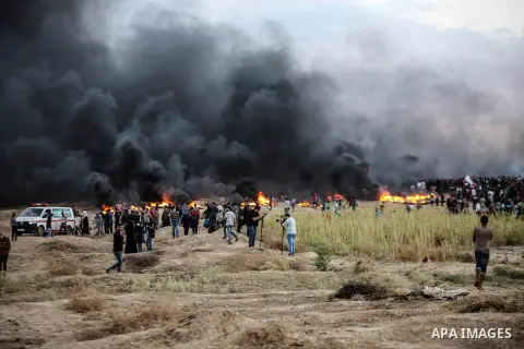 Palestinian protesters gather during clashes with Israeli troops in tents protest where Palestinians demand the right to return to their homeland at the Israel-Gaza border, in east of Gaza City on October 26, 2018. Photo...