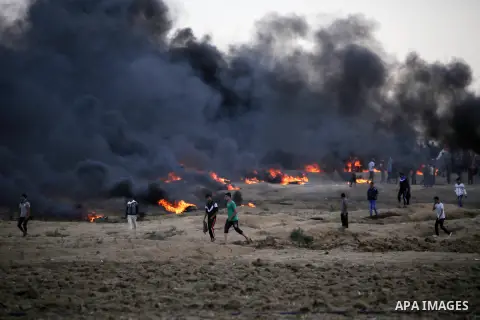 Palestinian protesters gather during clashes with Israeli troops in tents protest where Palestinians demand the right to return to their homeland at the Israel-Gaza border, in east of Gaza City on October 26, 2018. Photo...
