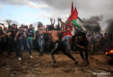 Palestinian protesters gather during clashes with Israeli troops in tents protest where Palestinians demand the right to return to their homeland at the Israel-Gaza border, in east of Gaza City on October 26, 2018. Photo...