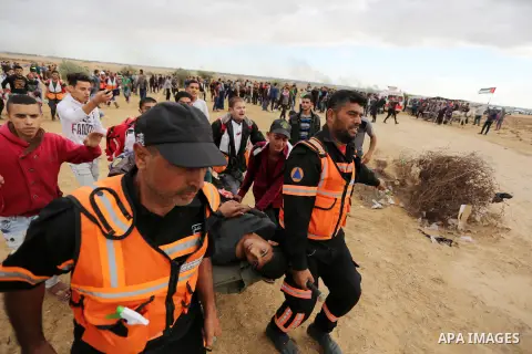 A wounded Palestinian protester is evacuated during clashes with Israeli troops in tents protest where Palestinians demand the right to return to their homeland at the Israel-Gaza border, in Khan Youins in the southern G...
