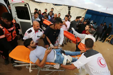 A wounded Palestinian protester is evacuated during clashes with Israeli troops in tents protest where Palestinians demand the right to return to their homeland at the Israel-Gaza border, in Khan Youins in the southern G...