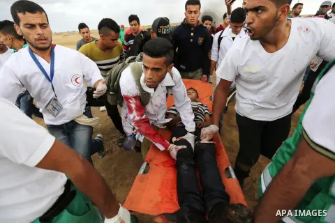 A wounded Palestinian protester is evacuated during clashes with Israeli troops in tents protest where Palestinians demand the right to return to their homeland at the Israel-Gaza border, in Khan Youins in the southern G...