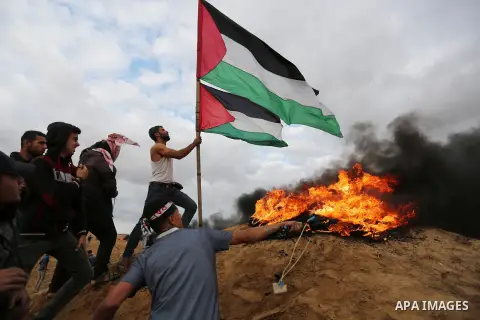 Palestinian protesters gather during clashes with Israeli troops in tents protest where Palestinians demand the right to return to their homeland at the Israel-Gaza border, in Khan Youins in the southern Gaza Strip on Oc...
