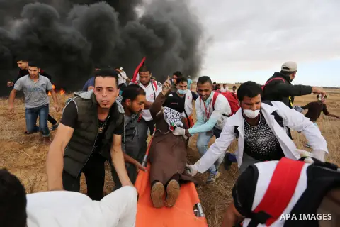 A wounded Palestinian protester is evacuated during clashes with Israeli troops in tents protest where Palestinians demand the right to return to their homeland at the Israel-Gaza border, in Khan Youins in the southern G...