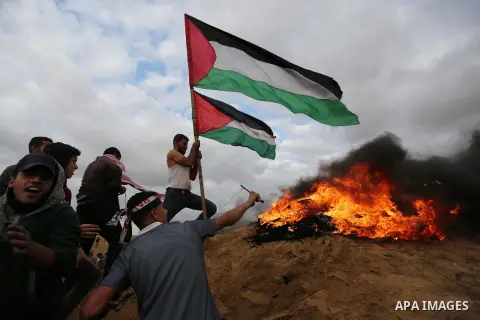 Palestinian protesters gather during clashes with Israeli troops in tents protest where Palestinians demand the right to return to their homeland at the Israel-Gaza border, in Khan Youins in the southern Gaza Strip on Oc...