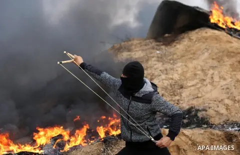 Palestinian protesters gather during clashes with Israeli troops in tents protest where Palestinians demand the right to return to their homeland at the Israel-Gaza border, in Khan Youins in the southern Gaza Strip on Oc...