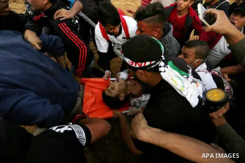 Palestinian protesters gather during clashes with Israeli troops in tents protest where Palestinians demand the right to return to their homeland at the Israel-Gaza border, in Khan Youins in the southern Gaza Strip on Oc...