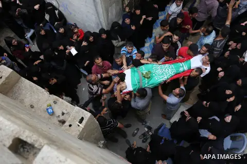 Mourners carry the body of Palestinian Ahmed Abu Lebda, 22, who was shot dead by Israeli forces during clashes in tents protest where Palestinians demand the right to return to their homeland at the Israel-Gaza border, d...
