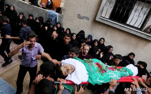 Mourners carry the body of Palestinian Ahmed Abu Lebda, 22, who was shot dead by Israeli forces during clashes in tents protest where Palestinians demand the right to return to their homeland at the Israel-Gaza border, d...
