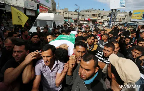 Mourners carry the body of Palestinian Ahmed Abu Lebda, 22, who was shot dead by Israeli forces during clashes in tents protest where Palestinians demand the right to return to their homeland at the Israel-Gaza border, d...