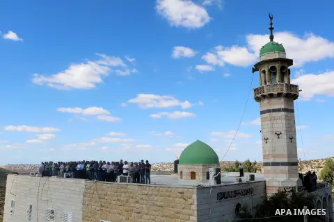 Mourners pray at a mosque during the funeral of Palestinian Othman Ladadwah, who was shot dead by Israeli forces during clashes the day before, in the village of Al-Mazraa Al-Gharbeya, in the West Bank city of Ramallah o...