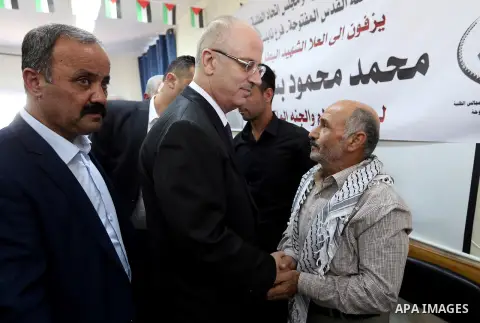 Palestinian Prime Minister Rami Hamdallah offers condolences for the family of Mohammed Basharat, who was shot dead by Israeli forces last Wednesday, in the village of Taamun near the West Bank city of Tubas, on October...